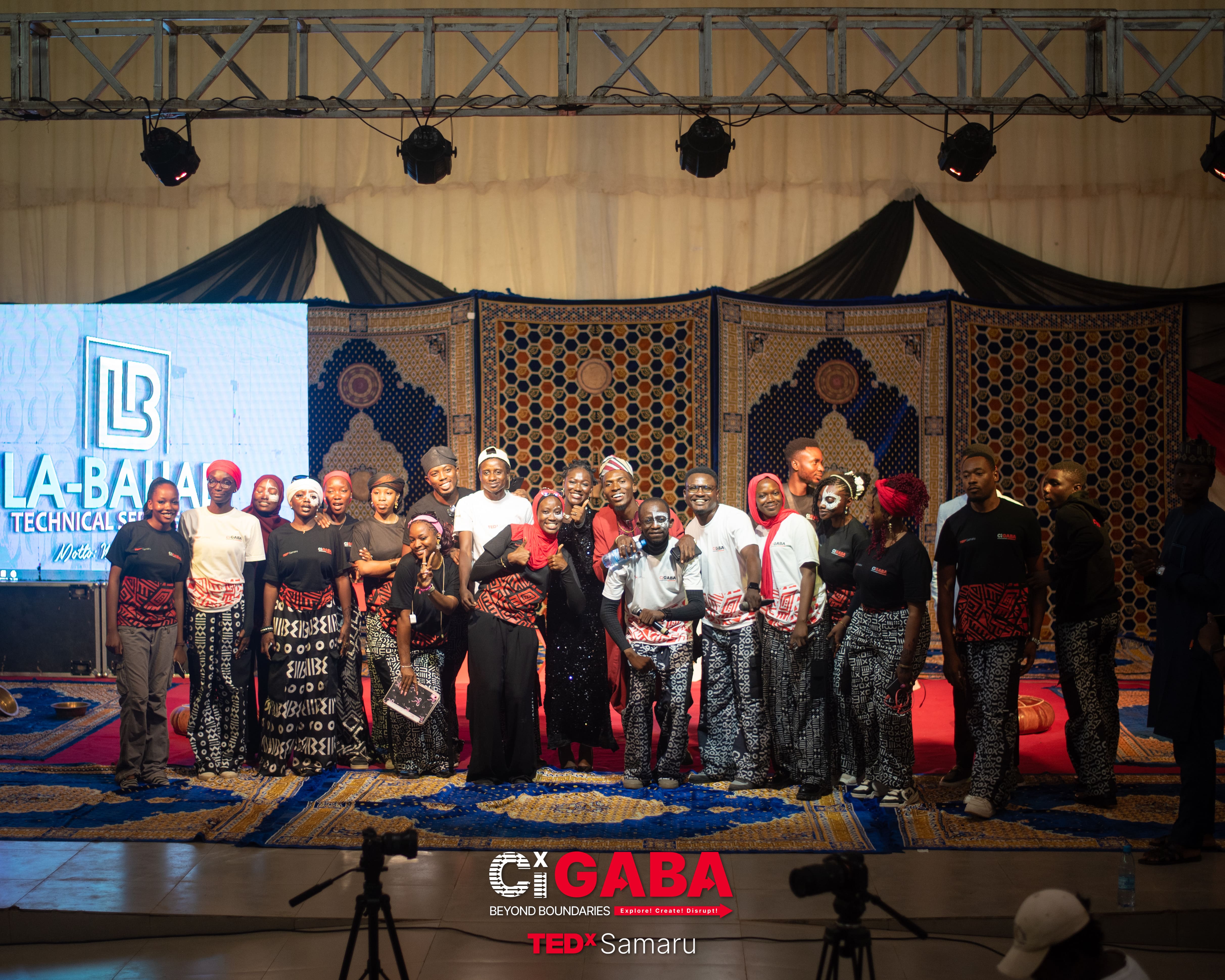 TEDx stage with a speaker and audience
